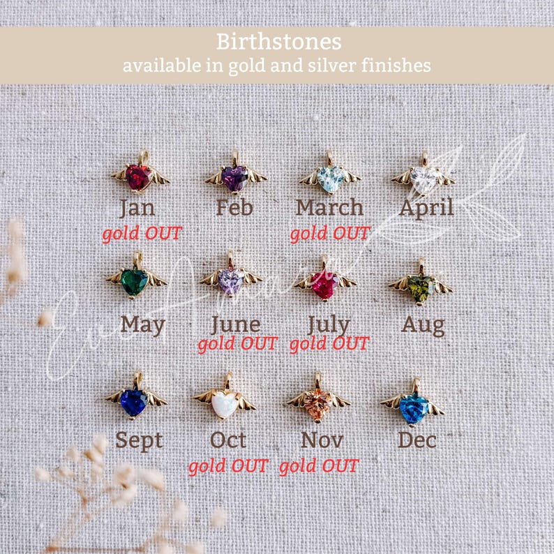 May include: A selection of heart-shaped birthstone pendants with gold wings, each representing a month. Text indicates availability in gold and silver finishes. Some months are marked as "gold OUT".
