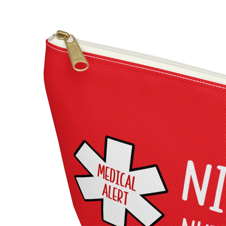 May include: Red zippered pouch with a white medical alert symbol and the text "MEDICAL ALERT" inside the symbol. The text "NICE TO MEET YOU, I HAVE A MEDICAL ALERT" is printed below the symbol.