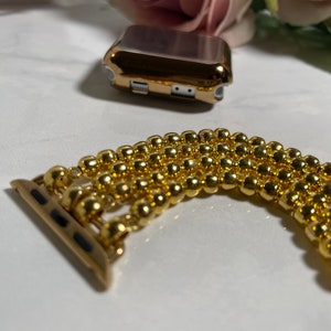 Puede incluir: Pulsera de reloj Apple dorada hecha de varias filas de peque&ntilde;as cuentas redondas.