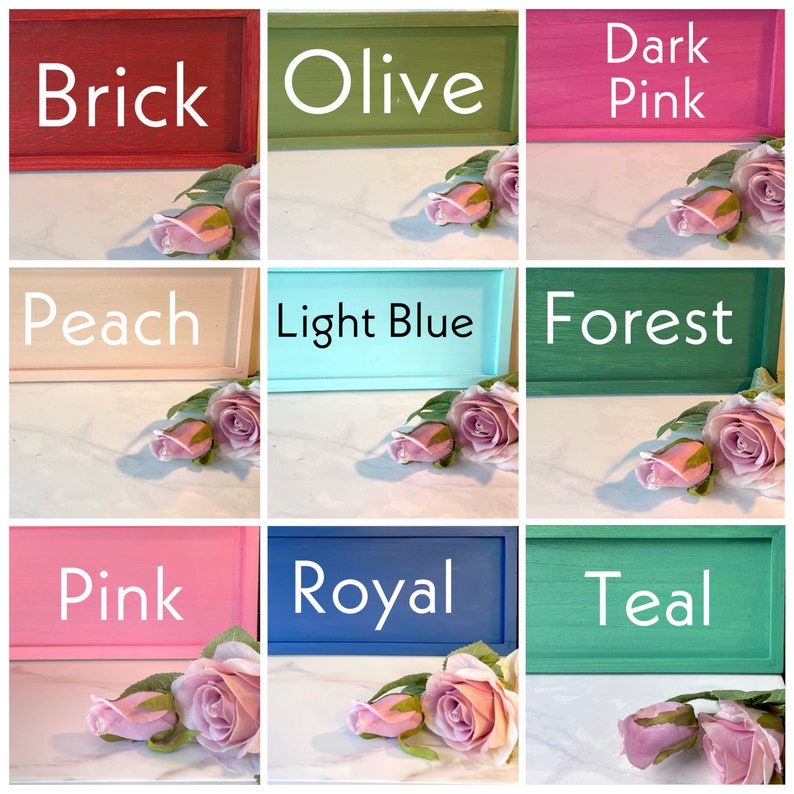 May include: Nine wooden signs with different paint colors and names: Brick, Olive, Dark Pink, Peach, Light Blue, Forest, Pink, Royal, Teal. Each sign is framed with a thin wooden border.