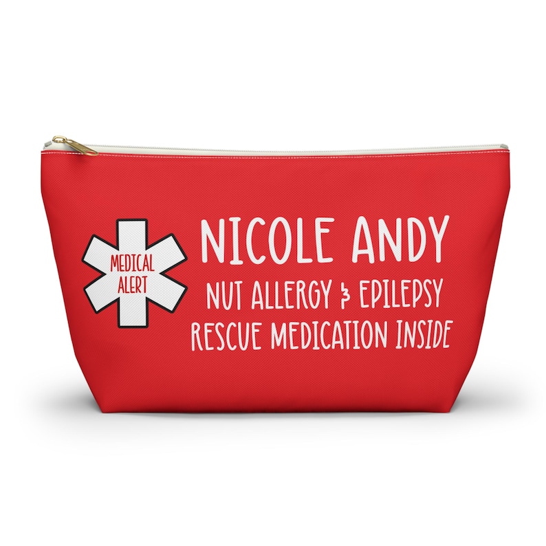 May include: Red zippered pouch with white text that reads "Nicole Andy Nut Allergy & Epilepsy Rescue Medication Inside" and a medical alert symbol.