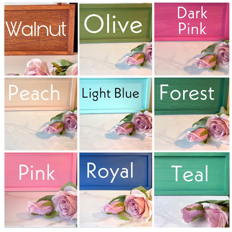 May include: Nine rectangular wooden signs in various colors, including walnut, olive, dark pink, peach, light blue, forest, pink, royal, and teal. Each sign displays a color name in white text and is accompanied by pink roses.