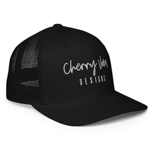 May include: Black trucker hat with a white embroidered logo that says "Cherry Wren Designs".