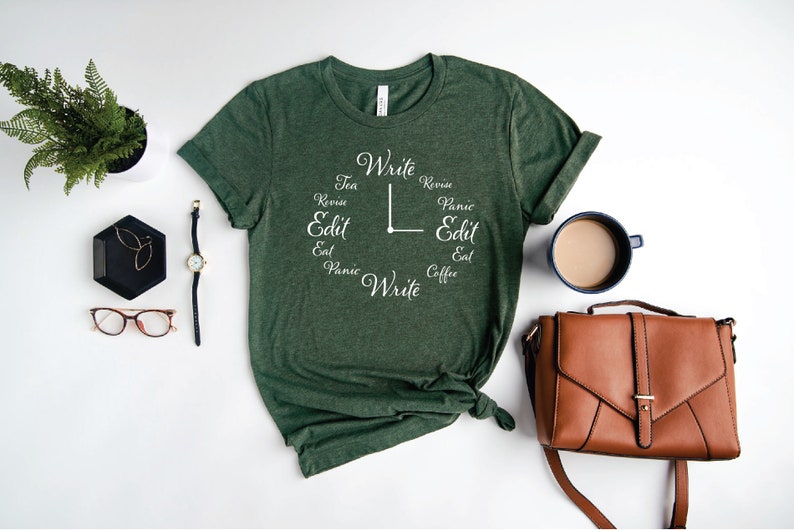 May include: A green t-shirt with a white clock design that says 'Write, Revise, Edit, Eat, Panic, Write, Tea, Revise, Panic, Edit, Eat, Coffee'.