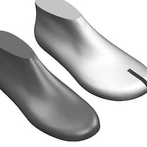 May include: Two grey shoe lasts, one with a split toe, used for making shoes.