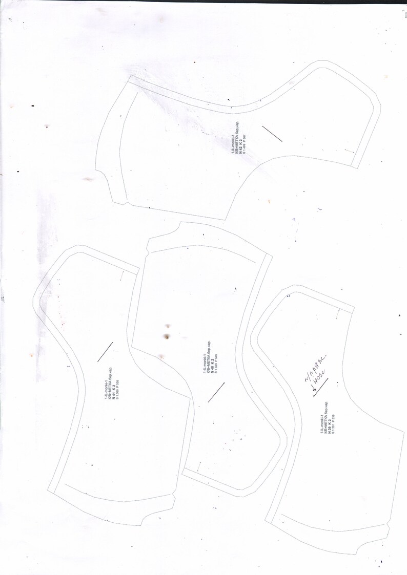 May include: Four white paper patterns for sewing a garment. The patterns are labeled with measurements in inches.