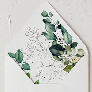 May include: A white envelope with a green and white floral design on the inside flap. The envelope is folded and the flap is closed. The text "Tento" is visible in the bottom right corner of the image.