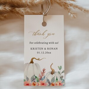 May include: White thank you tag featuring a watercolour illustration of pumpkins and flowers. The text reads "thank you" and "For celebrating with us!" with the names "KRISTEN & RONAN" and the date "01.12.20xx". The tag is from "Tento".