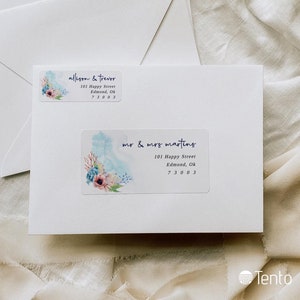 May include: Two white envelopes with return address labels. The top label reads "allison & trevor 101 Happy Street Edmond, Ok 73003". The bottom label reads "mr & mrs marting 101 Happy Street Edmond, Ok 73003". Both labels feature a watercolor design of flowers and coral.