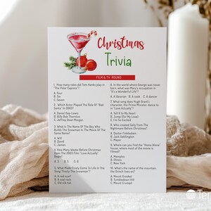 May include: A white card with "Christmas Trivia" in red and green script, featuring a cocktail illustration with a candy cane and ornaments. The card includes a film and TV round with trivia questions.