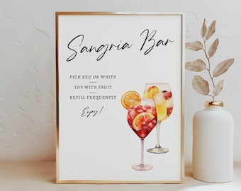 May include: A white sign with gold trim that reads "Sangria Bar". The sign has instructions for making sangria: "Pick red or white, top with fruit, refill frequently, Enjoy!"  The sign also features a watercolor illustration of two glasses of sangria.
