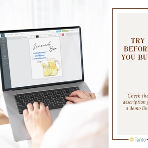 May include: A laptop computer displaying a digital design for a lemonade bar sign. The design features a watercolor illustration of two glasses of lemonade and a pitcher of lemonade with lemons.