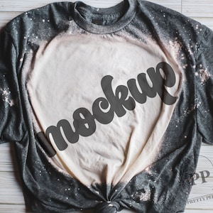 May include: A gray t-shirt with a white bleached design and the word "mockup" in black lettering.
