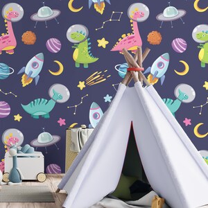 May include: A white teepee tent with a blue and white patterned background featuring dinosaurs, rockets, stars, and planets. The teepee is set up in a room with a wooden floor and a rainbow rug.