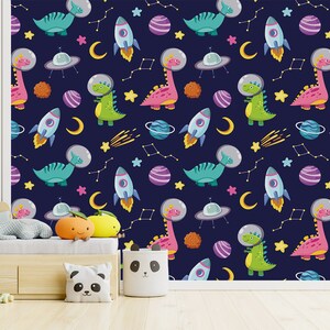 May include: A seamless pattern featuring colorful dinosaurs wearing astronaut helmets, rockets, planets, stars, and crescent moons on a dark blue background.