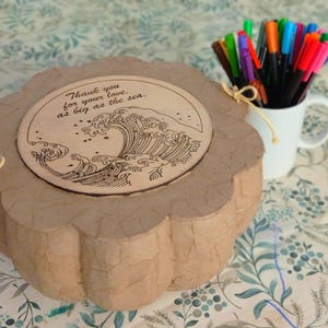 Personalized biodegradable sea burial urn with a heartfelt engraved message on the wooden lid, created for a meaningful farewell
