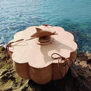 Close-up of a dolphin sea life symbol applied to the wooden lid of the SOUL SEA biodegradable water burial urn