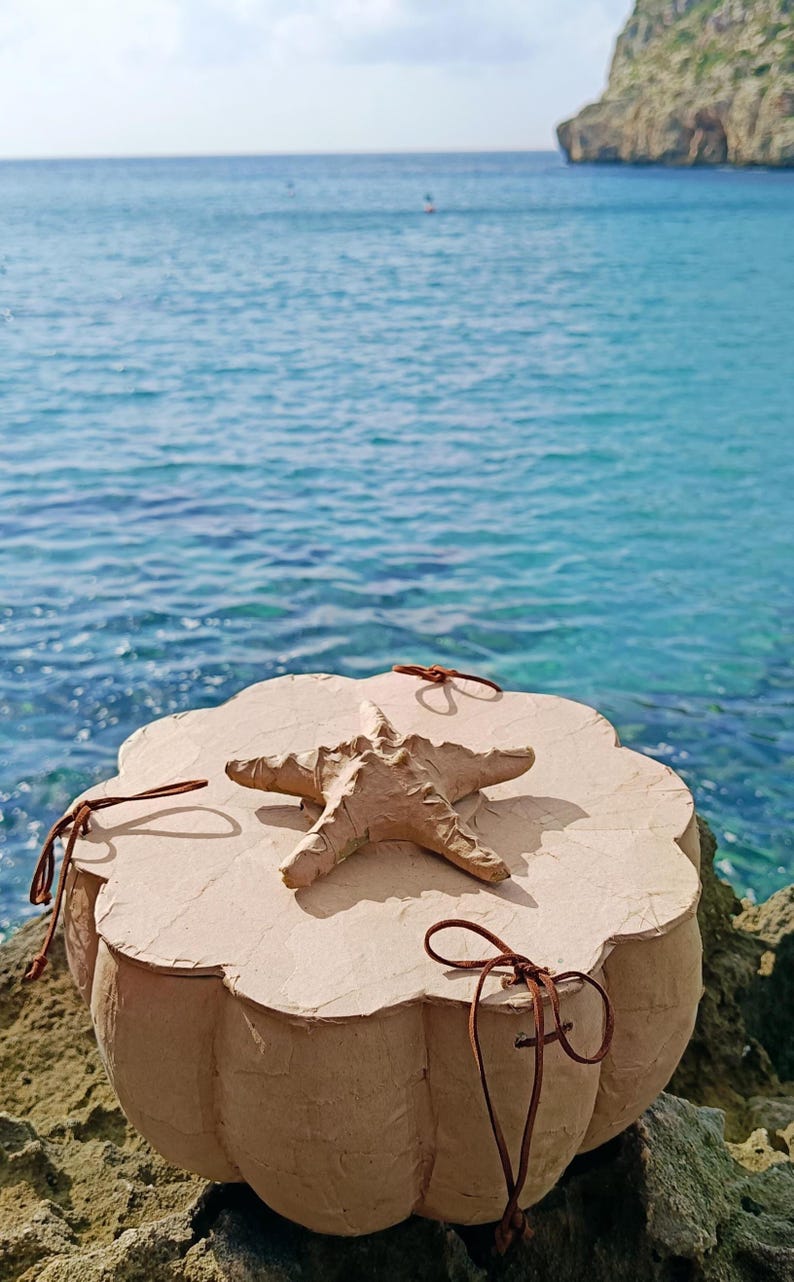 Starfish symbol on the wooden lid of a handmade SOUL SEA biodegradable urn designed for water burial
