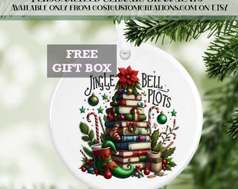 May include: A white ceramic Christmas bauble featuring a book stack Christmas tree, a red poinsettia, and the text "Jingle Bell Plots".