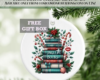 May include: A white ceramic Christmas bauble featuring a stack of books with a green, red and white colour scheme. The books are decorated with a red bow, candy canes and holly. The top book has the words "Jingle Books" written on it.