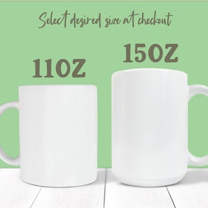 May include: Two white ceramic mugs, one 11 oz and one 15 oz, on a white wooden surface. Select desired size at checkout.