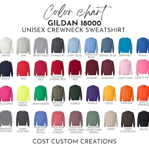 Op de afbeelding: Kleurenkaart voor Gildan 18000 unisex crewneck sweatshirts. De kaart toont een verscheidenheid aan kleuren, waaronder wit, as, sportgrijs, antraciet, lichtblauw, Carolina blauw, indigo blauw, saffier, koninklijk blauw, marineblauw, rood, kersenrood, antiek kersenrood, kardinaalrood, granaat, donkerrood, lichtroze, veiligheidsroze, heliconia, veiligheidsgroen, Iers groen, militair groen, bosgroen, paars, goud, oranje, veiligheidsoranje, grafiet melange, donker melange, heather sport royal, heather sport scarlet, heather sport donker maroon, heather sport donker groen, zand, donker chocolade en zwart.