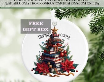 May include: White ceramic Christmas ornament featuring a tree made of books, decorated with red poinsettias, gold ribbon, and a star. The text "Unwrap a Chapter" is displayed. The ornament includes the text "Personalized Ceramic Ornaments" and "Free Gift Box".