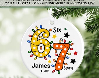 May include: White ceramic ornament with the numbers 6 and 7 decorated with colorful lights. The ornament includes the name "James", the year "2025", and the words "Six" and "Seven". The text "PERSONALIZED CERAMIC ORNAMENTS" is at the top.