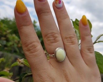 Silver ring with a small oval amber stone