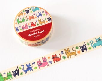 May include: A roll of washi tape with a repeating pattern of colorful cartoon cats. The tape is beige with cats in various colors, including green, blue, orange, and pink. The roll has a red label that reads "Washi Tape".