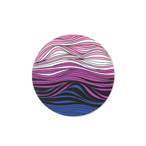 May include: A round coaster featuring a wavy pattern in shades of pink, purple, black, and blue.