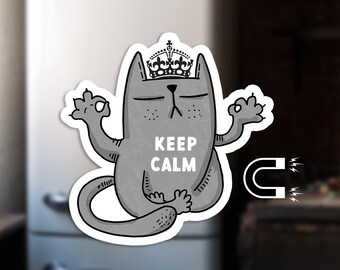 May include: A gray cat wearing a crown sits in a yoga pose with the text "Keep Calm" on its chest. The cat is a magnet and has a magnetic backing.