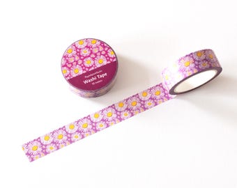 May include: A roll of purple and white washi tape with a daisy pattern. The tape is 10 meters long and is packaged in a clear plastic container with a label that says "Washi Tape".