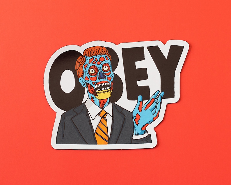 May include: A sticker with a black and white graphic of the word "OBEY" and a cartoon image of a man with a blue and red face wearing a suit and tie. The man is holding out his right hand.