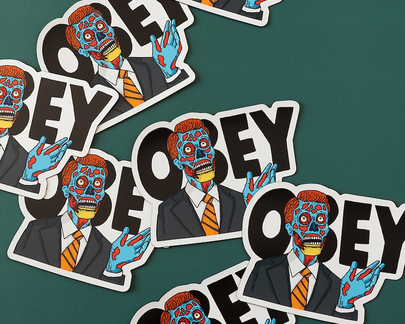 May include: Multiple stickers featuring a blue and red alien character with the word "OBEY" in black text.