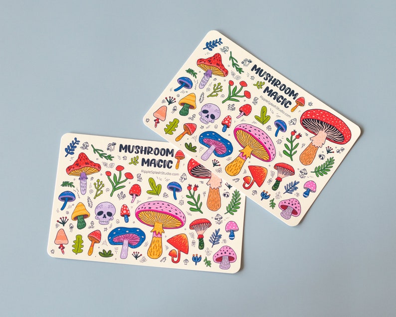 May include: Two colorful sticker sheets with a mushroom theme. The stickers feature various types of mushrooms, skulls, and foliage in a whimsical style. The text "Mushroom Magic" is printed on each sheet.