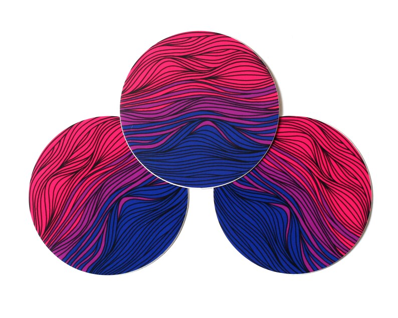 May include: Three round coasters with a wavy, abstract design in shades of pink, purple, and blue.