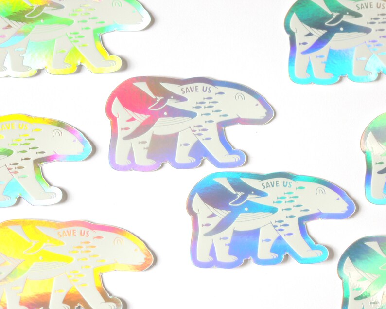 May include: A set of nine iridescent holographic stickers featuring a polar bear with a whale on its back. The stickers have the text "Save Us" and a school of fish swimming around the animals.