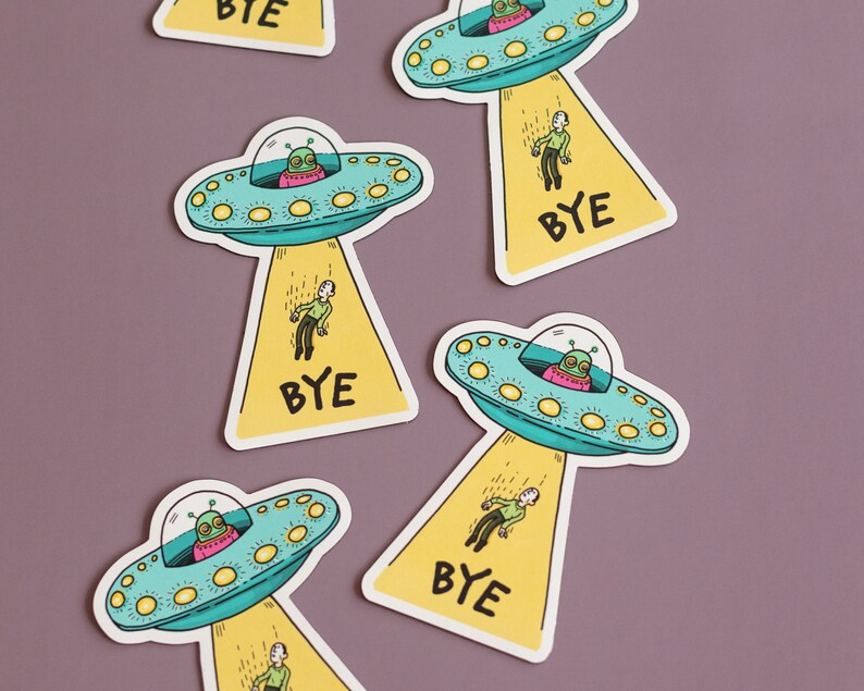 May include: Five colorful stickers with cartoon illustrations of spaceships and aliens. Each sticker has the word "BYE" printed on it.
