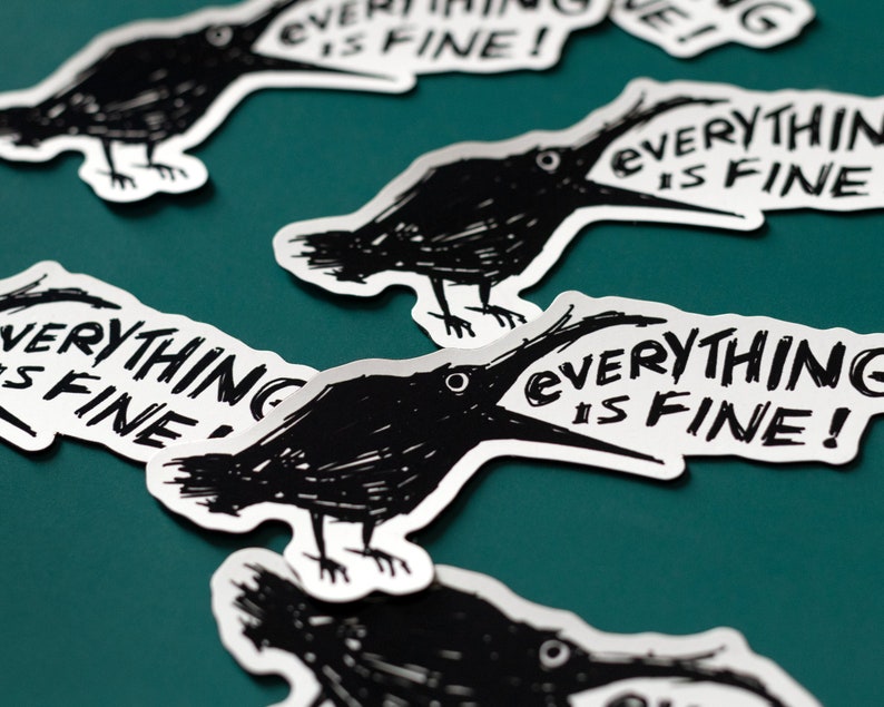 May include: Four black and white stickers with a crow illustration and the text "Everything is fine!" printed on them. The stickers are on a teal surface.