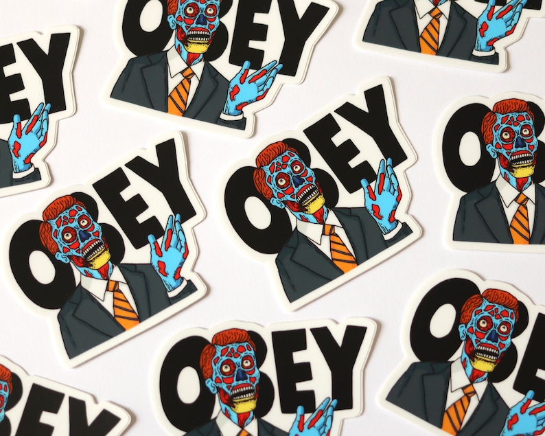 May include: A set of nine stickers featuring a cartoon character with a split face, wearing a suit and tie, with the word "OBEY" in black letters. The stickers are on a white background.