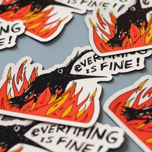 May include: A set of black and white stickers with a cartoon crow on fire. The stickers say "Everything is fine!" in a black and white hand-drawn font.