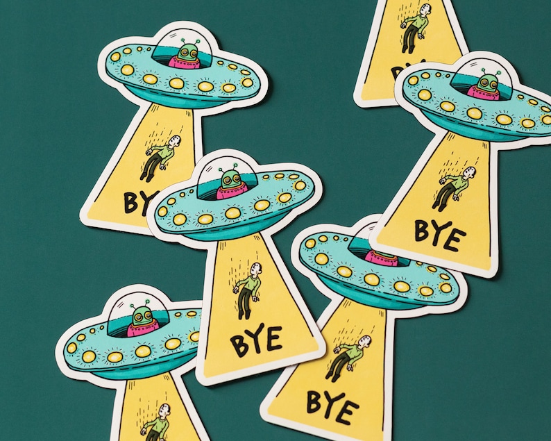 May include: A set of six yellow and green alien-themed stickers with the word "BYE" on each. The stickers feature cartoon aliens in flying saucers with people falling from the saucers.