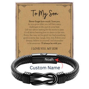 May include: A black braided leather bracelet with a stainless steel clasp, personalized with the name "Noah". The bracelet is displayed with a card that reads "To My Son" and a heartfelt message. The words "Custom Name" are also visible.