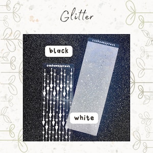 May include: Two sheets of glitter, one black and one white. The white sheet has a pattern of stars and diamonds on it. The text "sunbeansprout" is printed on both sheets.
