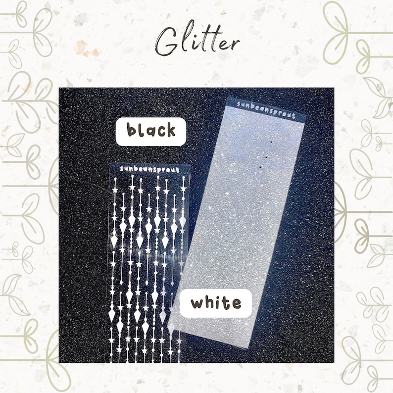 May include: Two sheets of glitter, one black and one white. The white sheet has a pattern of stars and diamonds on it. The text "sunbeansprout" is printed on both sheets.