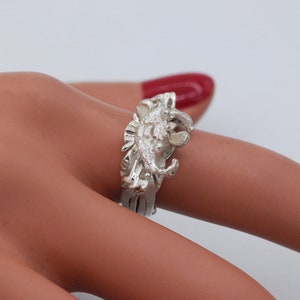 Könnte beinhalten: Ein silberner Ring mit einem detaillierten Krabben-Design. Die Krabbe ist nach rechts gerichtet und hat ihre Scheren erhoben.