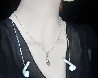 May include: A silver chain necklace with an infinity symbol pendant. The chain is also used as a headphone holder, with white earbuds attached to each end.