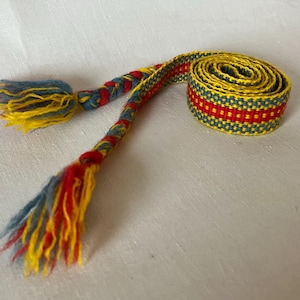 Mehrfarbiges Vintage-Handwebband. Handgewebter Gürtel. Viking Borte aus 100% Wolle. Hergestellt in den 70er Jahren in Schweden. Mit 2 großen Quasten.