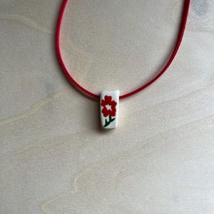 Ceramic red flower bead necklace with faux suede cord